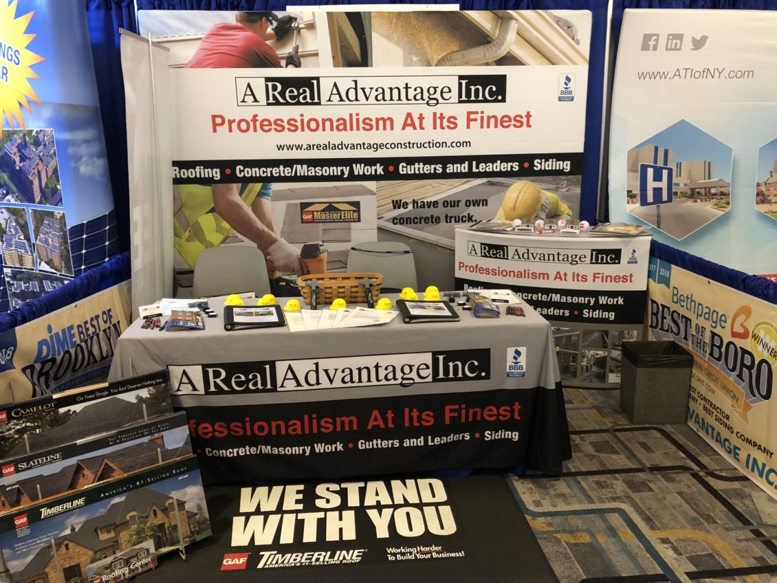 Construction worker putting the asphalt roofing